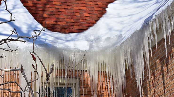 Accumulation de glace sur la toiture d'une maison.